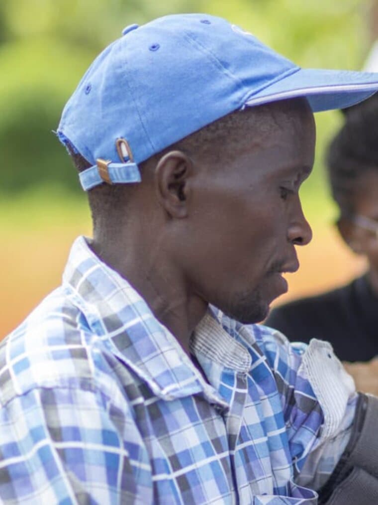 A man has his blood pressure taken at an outdoor community screening.